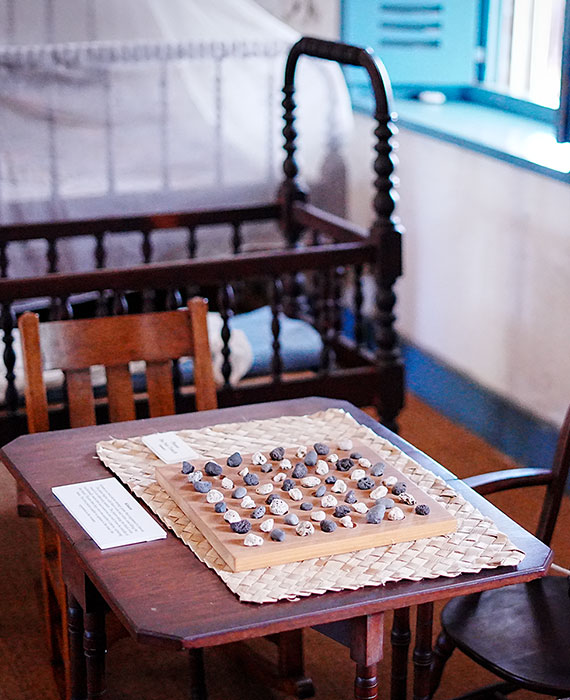 image of Hawaiian Konane game board set up in the Baldwin Home Museum.